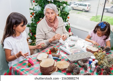 Grandmother Teaching Her Granddaughters How To Make Christmas Nativity Crafts - Real Family