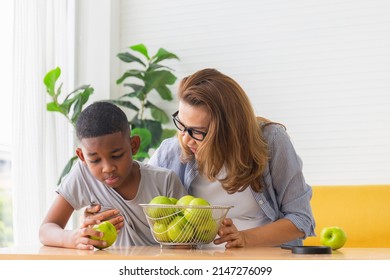 Grandmother Touch Grandson For Encouragement In Kitchen Room, Mature Woman Comforting And Giving Encouragement To Kid Boy