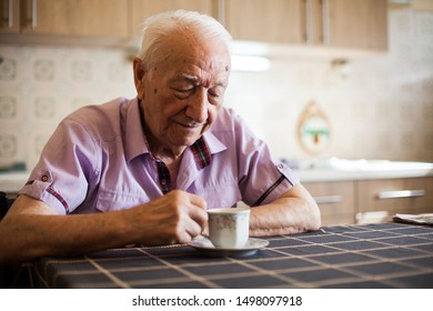 Grandpa drinking morning coffee in the kitchen, elderly caucasian gentleman enjoying retirement life,contemplative facial expression,reminiscing of old times and young days,satisfied content and happy - Powered by Shutterstock