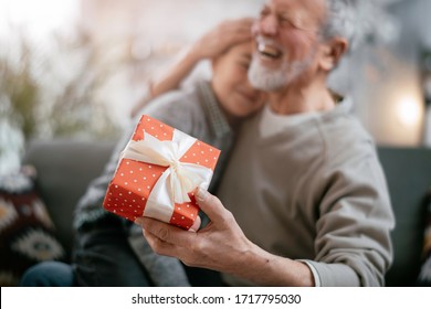 Grandpa Giving His Grandson Birthday Gift. Grandfather Becomes Present From Grandchild.