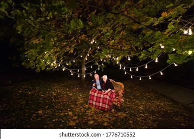 Grandpa And Grandma Drink Tea In The Park.