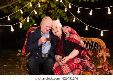 Grandpa And Grandma Drink Tea In The Park.