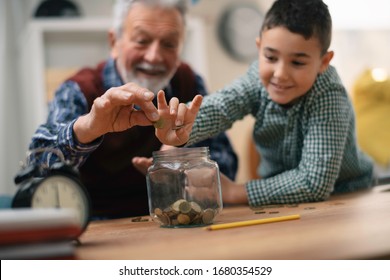 Grandpa And Grandson Saving Money. Grandfather Teaching Grandchild How To Save Money.