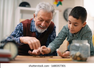 Grandpa And Grandson Saving Money. Grandfather Teaching Grandchild How To Save Money.