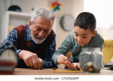 Grandpa And Grandson Saving Money. Grandfather Teaching Grandchild How To Save Money.