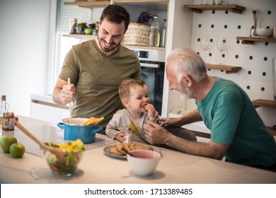Grandpa you are the best cook  Grandfather his adult son   grandson together in  kitchen  lunch 