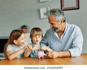 Grandparent grandfather And His Grandson and granddaughter Putting Coin Money In Piggybank  At Home. Personal Savings, Bank Safety And Financial Investments Concept