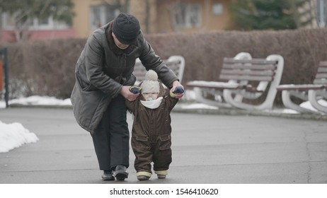 Grandparent Holding Baby Child Hand And Helping Toddler To Do First Steps, Grandmother And Grandchild Relationship