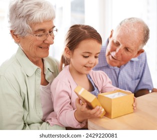 Grandparents, child and opening gift box for birthday or special event, old people and young girl for celebration. Gratitude, thanks for surprise and unboxing present with family bond and happiness - Powered by Shutterstock