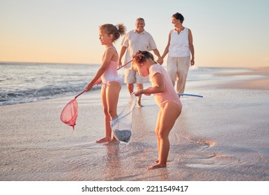 Grandparents And Children At The Beach With Fishing Nets And Having Fun. Young Kids And Senior Couple Enjoying Holiday With Grandkids And Retirement Together. Playing By The Sea In Summer With Family