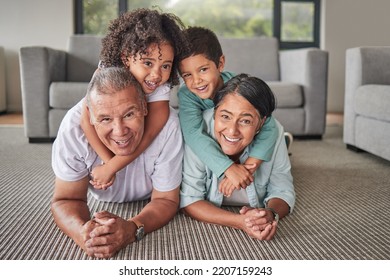 Grandparents, Children Or Bonding In Fun Play Game On House Or Family Home Living Room Floor. Portrait, Smile Or Happy Senior Man And Mature Woman Babysitting Grandchildren Or Kids Together In Lounge