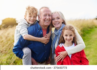 Grandparents With Children On Walk Through Countryside