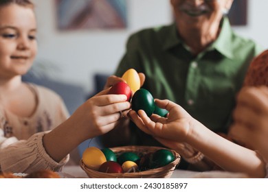 Grandparents and girl holding decorated easter eggs. Tradition of painting eggs with brush and easter egg dye. - Powered by Shutterstock