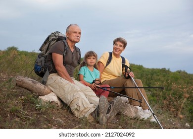 Grandparents And Grandchild With Backpack Hiking In Outdoor. Digital Detox. Staycations.  Hyper-local Travel, Family Outing, Getaway, Natural Environment