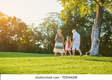 Grandparents And Grandchild Walking Outdoors. People, Sunny Summer Day.