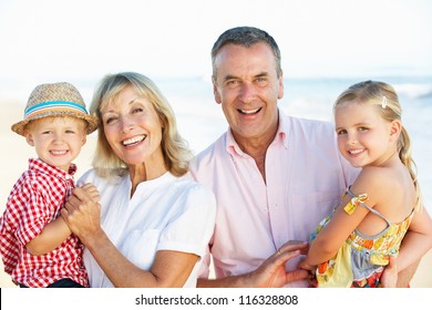 Grandparents And Grandchildren Enjoying Beach Holiday