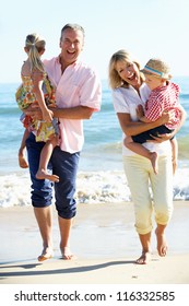 Grandparents And Grandchildren Enjoying Beach Holiday