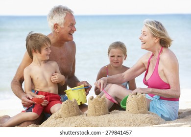 Grandparents And Grandchildren Enjoying Beach Holiday