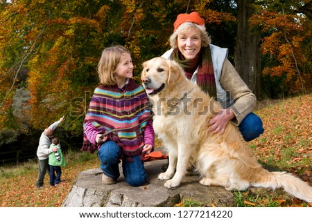 Grandfather and grandchildren exercise on a fitness facility in the park