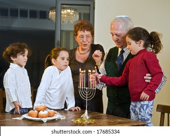 grandparents and grandchildren lightening Menorah  together