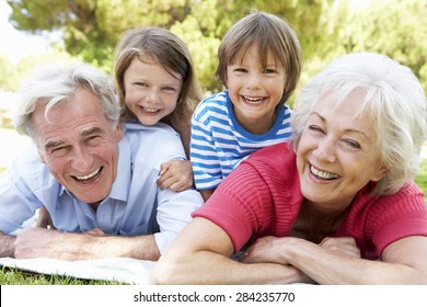 Grandparents And Grandchildren In Park Together