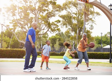 Grandparents And Grandchildren Playing Basketball Together