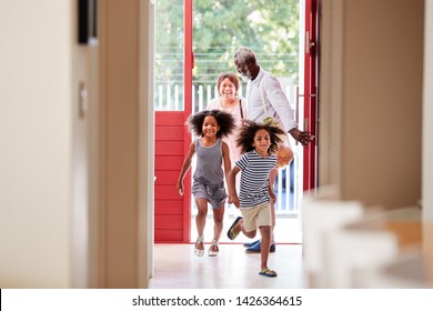 Grandparents With Grandchildren Returning Home From Shopping Trip Carrying Grocery Bags - Powered by Shutterstock