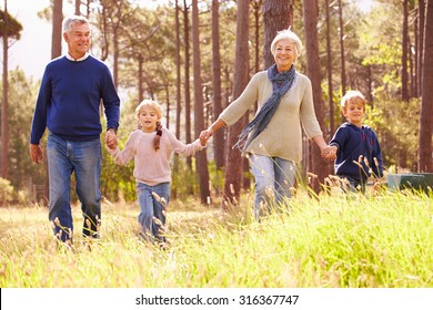 Grandparents And Grandchildren Walking In The Countryside