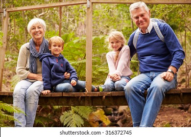 Grandparents With Grandkids On Bridge In A Forest, Portrait