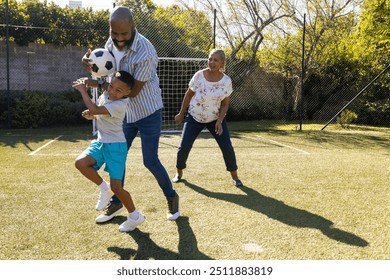 grandparents and grandson enjoying outdoor activity, playing soccer in backyard. sports, togetherness, recreation, fun, bonding - Powered by Shutterstock