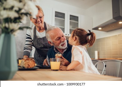 Grandparents having breakfast with their granddaughter - Powered by Shutterstock