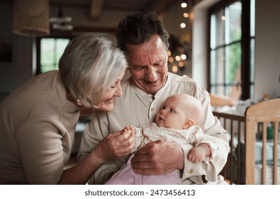 Grandparents holding baby girl, calming her down, soothing her. Strong bond between grandparents and grandchild. - Powered by Shutterstock