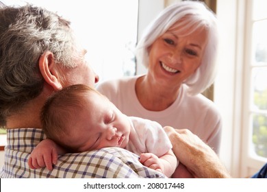 Grandparents Holding Sleeping Newborn Baby Granddaughter - Powered by Shutterstock