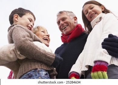 Grandparents Hugging Their Grandchildren