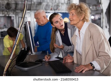 Grandparents And Kids Standing In Escape Room And Using Computer To Solve Riddles.
