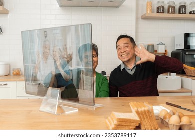 Grandparents on computer communicating with grandkids via video chat from home kitchen, holiday activities for retired couples, Senior health care and wellness mental concept. - Powered by Shutterstock