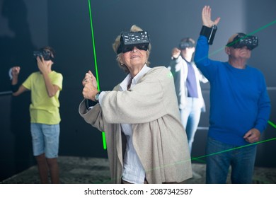 Grandparents Playing Games With Their Young Grandkids In VR Club.