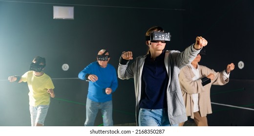 Grandparents Playing Games With Their Young Grandkids In VR Club.