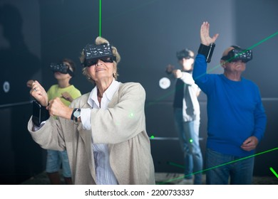 Grandparents Playing Games With Their Young Grandkids In VR Club.