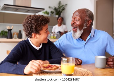 Grandparents Sitting In Kitchen With Grandson Eating Breakfast Before Going To School - Powered by Shutterstock