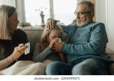 Grandparents taking care of their sick granddaughter. - Powered by Shutterstock