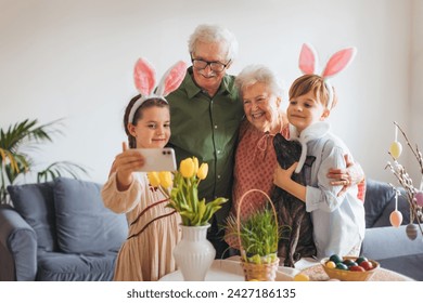 Grandparents taking selfie with grandchildren before traditional easter lunch. Recreating family traditions and customs. Happy easter. - Powered by Shutterstock