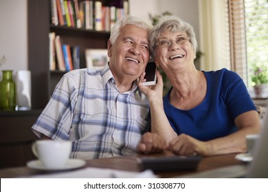 Grandparents talking on the phone at the table