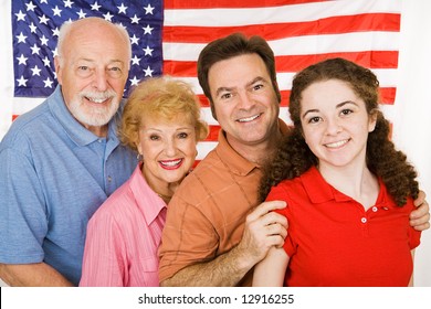 Grandparents, their adult child, and their granddaughter, posing in front of an American Flag. - Powered by Shutterstock