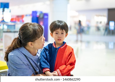 Grandson Is Crying, He Want To Buy Toys At The Department Store. Grandma Try To Teach Her Grandson To Understand Why She Can Not Buy Its.