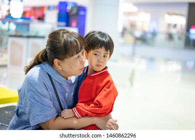 Grandson Is Crying, He Want To Buy Toys At The Department Store. Grandma Try To Teach Her Grandson To Understand Why She Can Not Buy Its.