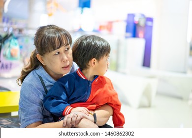 Grandson Is Crying, He Want To Buy Toys At The Department Store. Grandma Try To Teach Her Grandson To Understand Why She Can Not Buy Its.