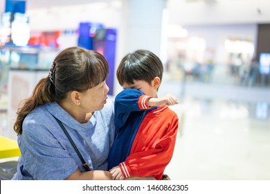 Grandson Is Crying, He Want To Buy Toys At The Department Store. Grandma Try To Teach Her Grandson To Understand Why She Can Not Buy Its.