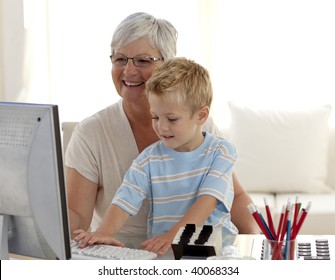 Grandson and grandmother using a computer at home - Powered by Shutterstock