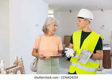 Grandson Helping Grandmother With Home Improvement, They Examining Plan Of Renovation And Planning Inner Works Together